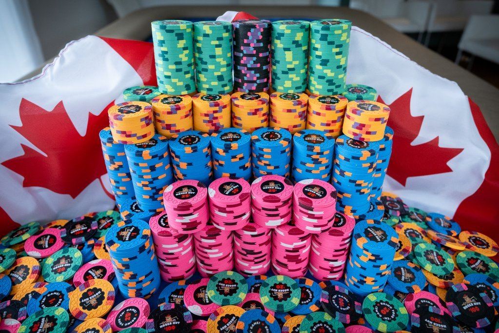Towers of brightly colored custom chips in front of a Canadian flag